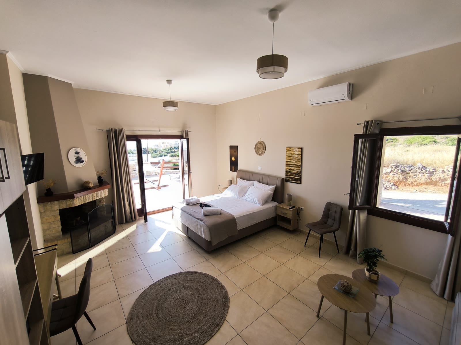 Spacious bedroom with desk and terrace in a Syros villa — suited to remote-working parents